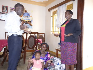 Ojambo Christopher and Betty Mukisa praying for Specioza